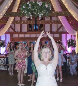 Bride throws the bouquet-Brookfield Barn