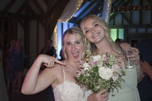 Bridesmaid caught the bouquet and got a picture with the bride-Brookfield Barn