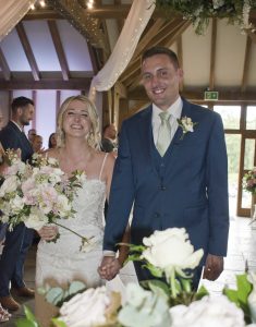 Bride and groom walk down the aisle Brookfield Barns 